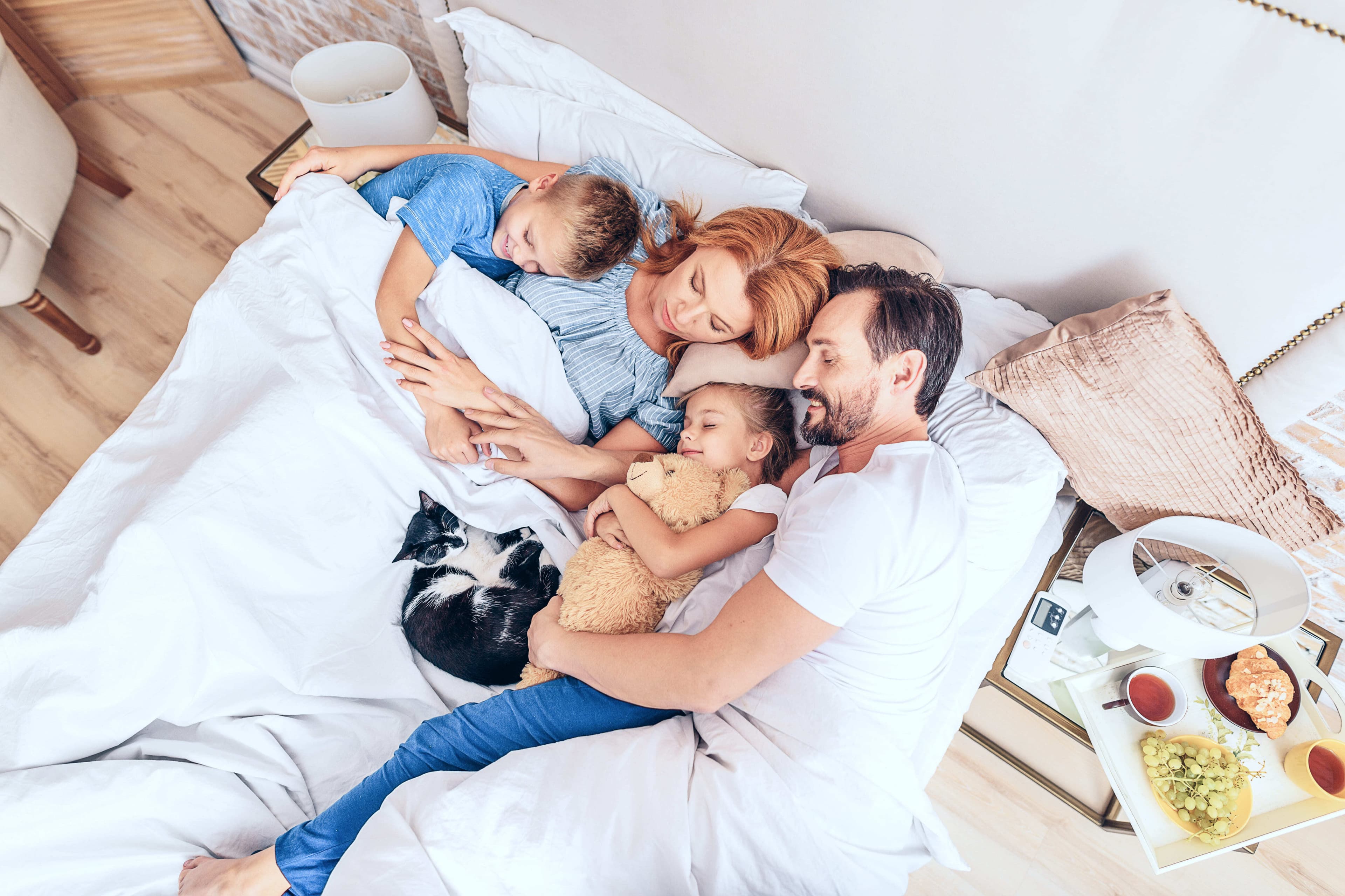 Family of four with their pet cat