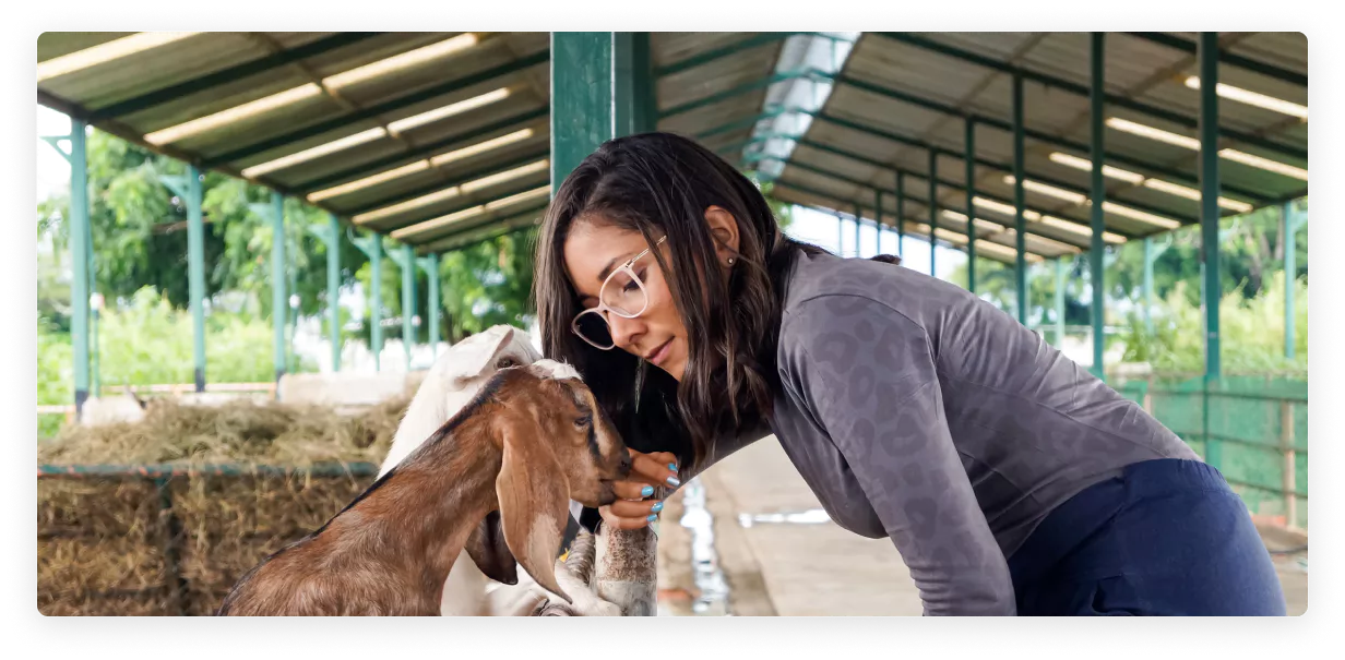 Woman with goat at a farm
